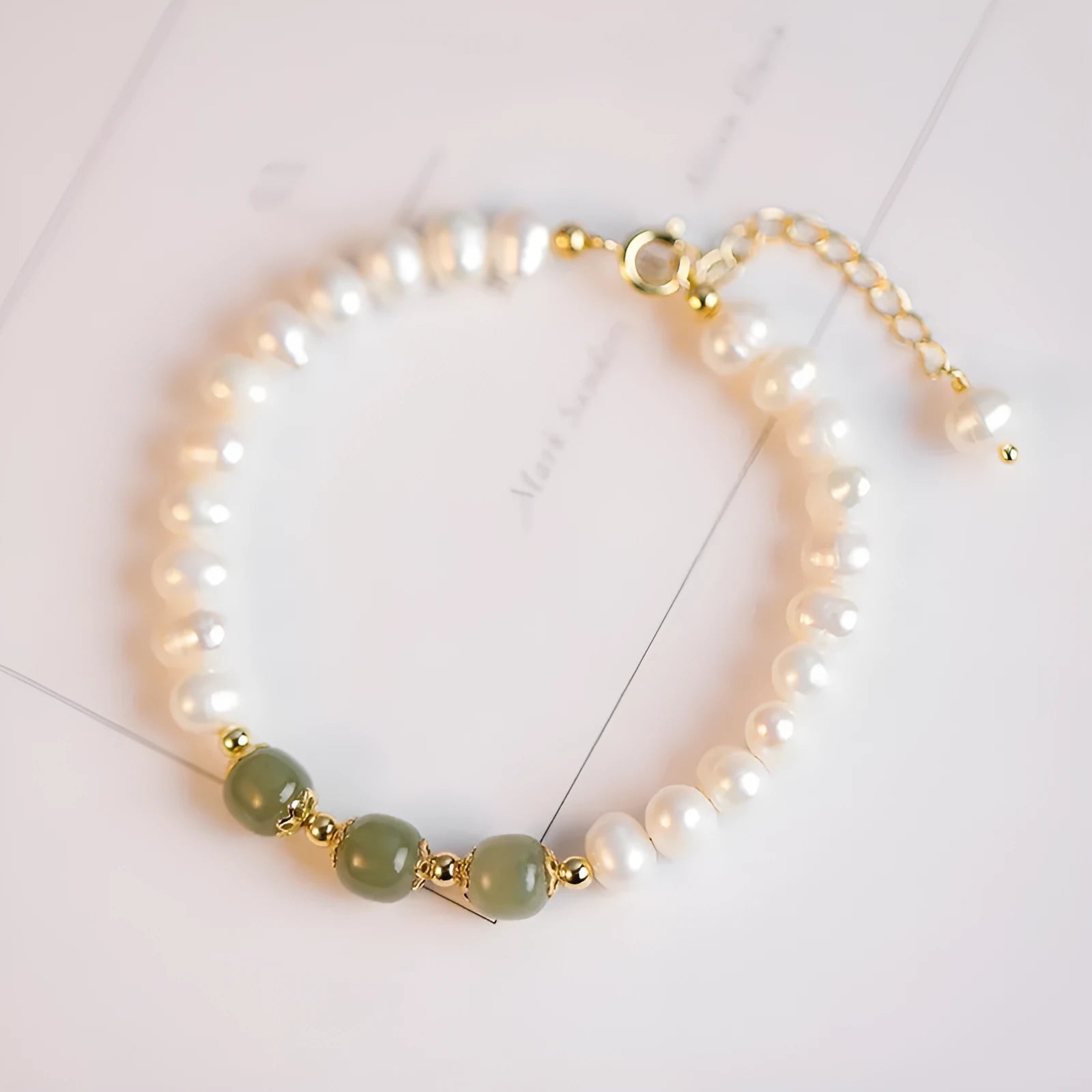Korean style natural freshwater pearl bracelet with diamond-shaped beads in a Hetian jade electroplated finish.