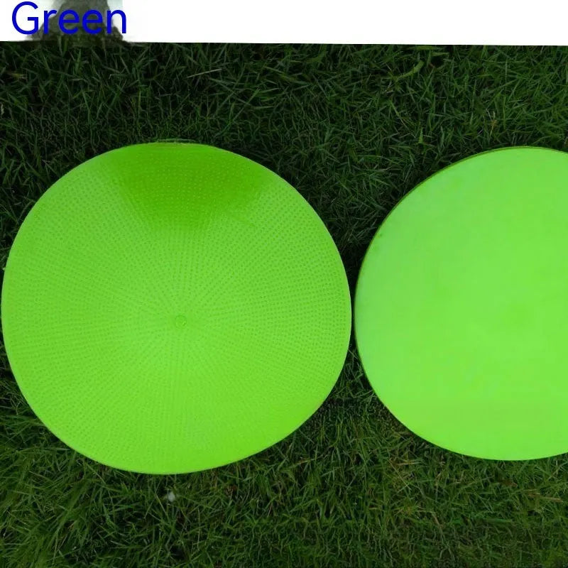 Soft yellow TPE football training landmark pad on grass, showing 23cm diameter.