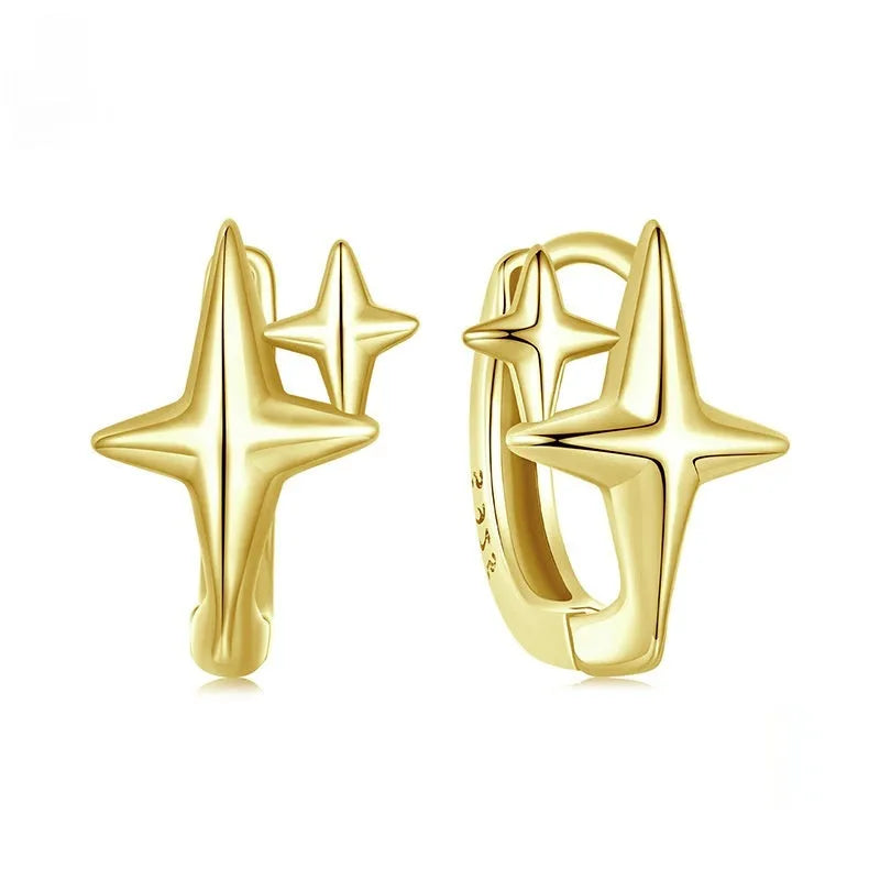 Minimalist oxidised sterling silver star ear clip with XINGX detail on a white background.