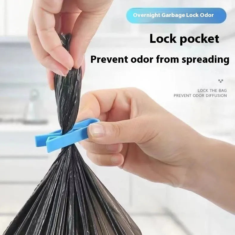 White PP plastic garbage bag fixing clip holding a black bin liner to a trash can rim.