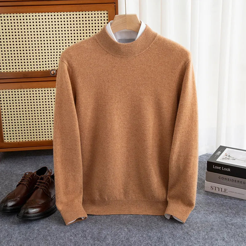 Man wearing a loose-fit, chunky knit wool sweater with a half-turtleneck collar in a neutral colour.