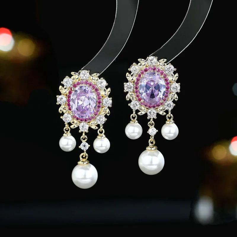 Oval geometric copper drop earrings with pearl elements, inlaid zircon treatment, and tassel detailing in light purple colour