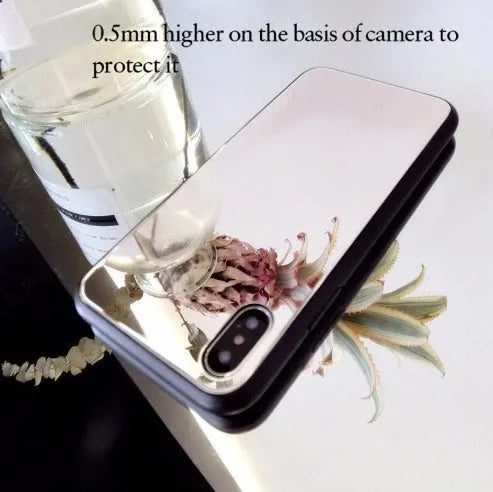 Black mirror iPhone back cover case for iPhone 7 Plus, 8 Plus, and X models on a table.