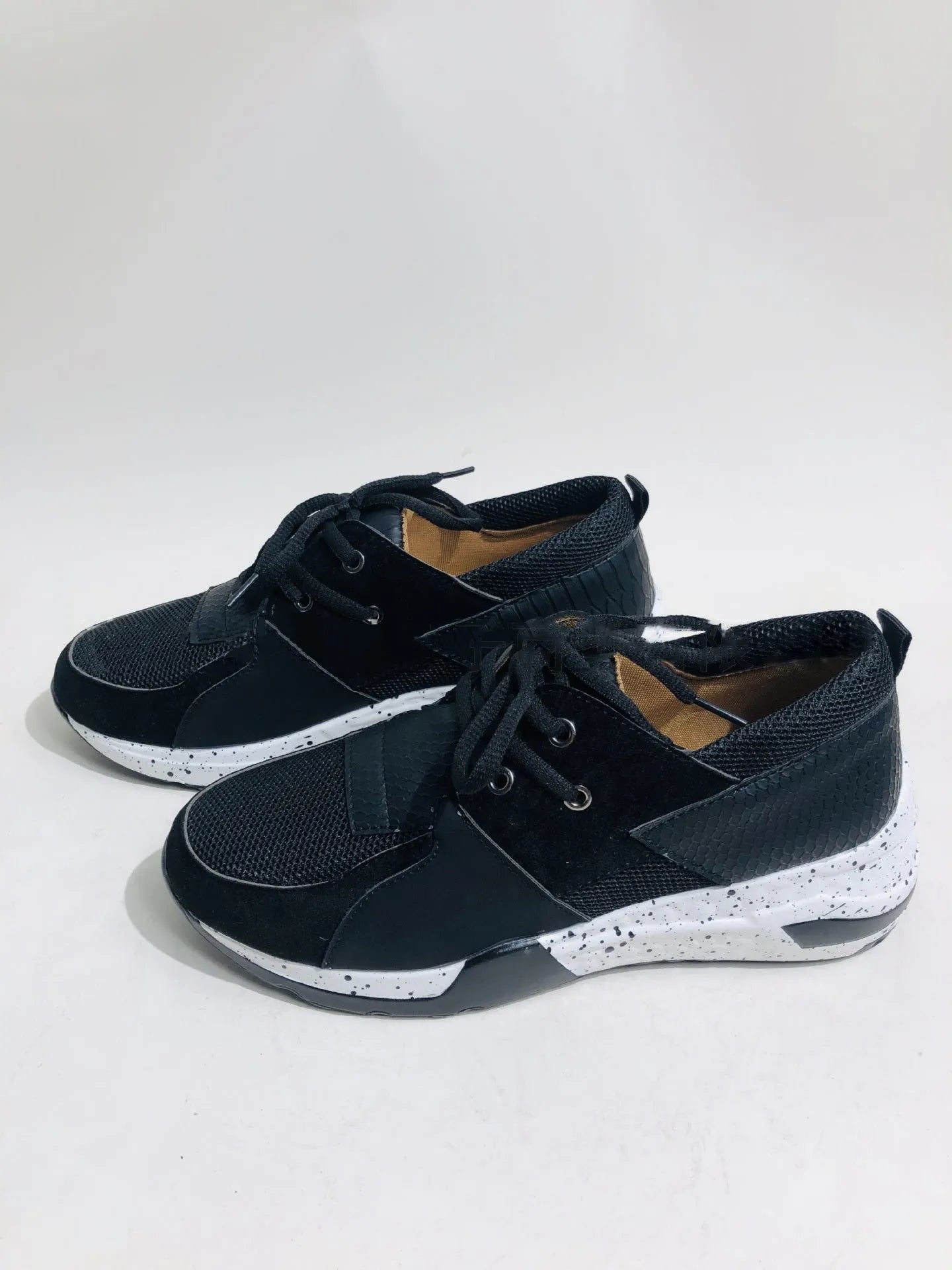 Women's black suede casual sneakers with a wedge heel on a white background
