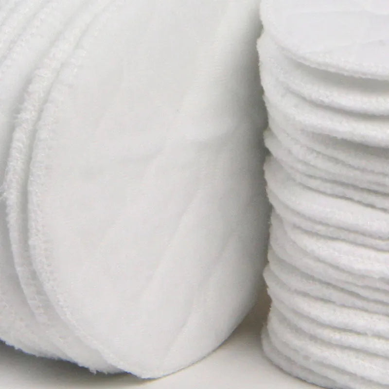 Pack of four white eco-cotton double-layer anti-galactorrhea nursing pads on a white background