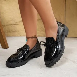 Women's brown and black loafers with bow detail on artificial PU upper, showing slip-on design