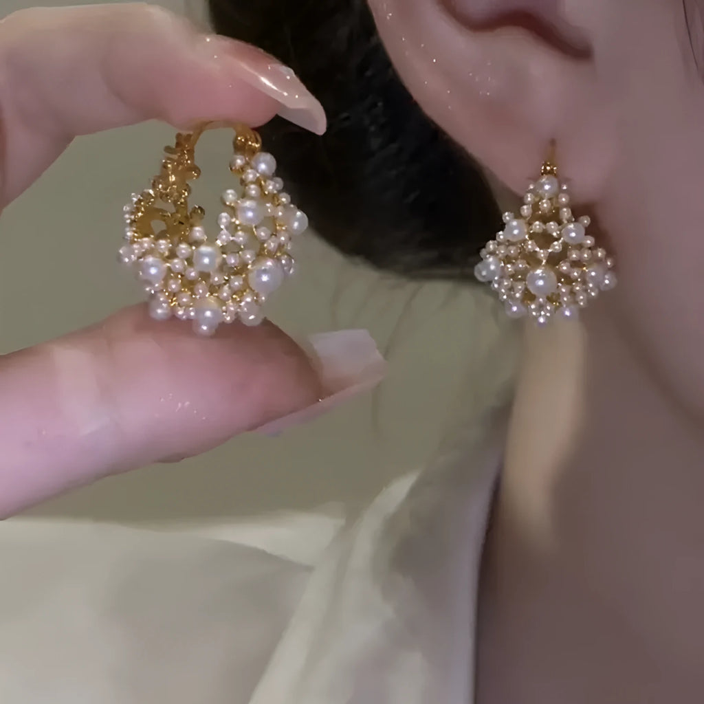 Gold-coloured women's flower basket earrings made from copper with small rice-shaped beads.