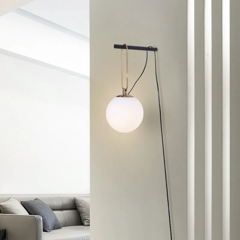 Nordic modern glass wall lamp mounted on a wall, showcasing its translucent design.