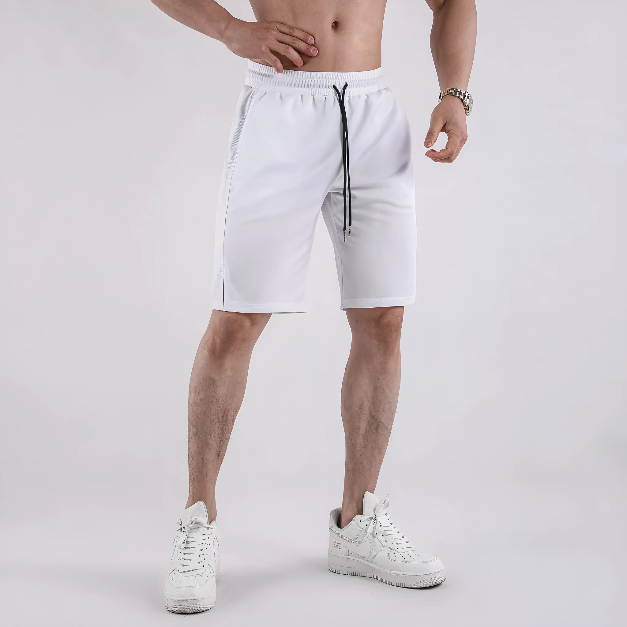 Man wearing black loose-fit quick-dry mesh shorts for summer sports.