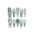 Green plastic nail armour suit with diamond accents and a gradient camellia chain decoration.