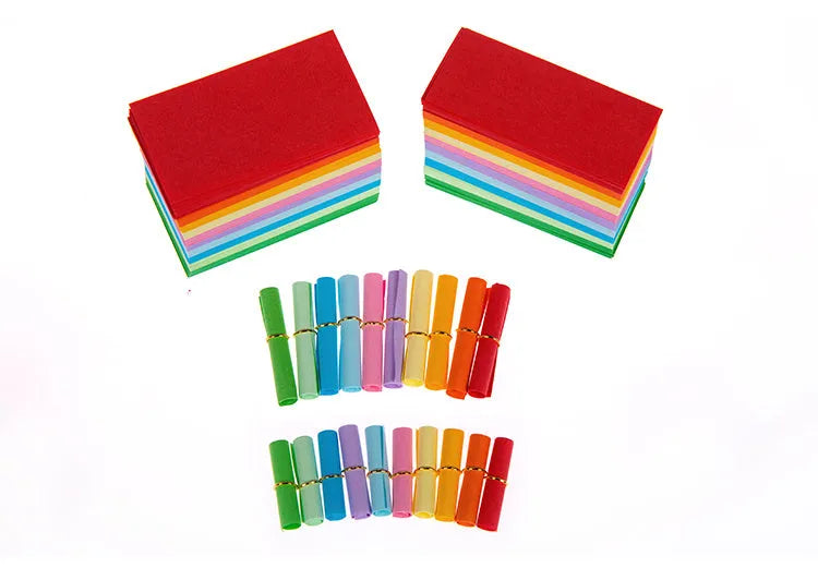 Assortment of colourful mini paper scrolls with metal eyelets in various sizes.