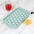 Blue silicone ice cube tray with lid showing 33 round ice moulds