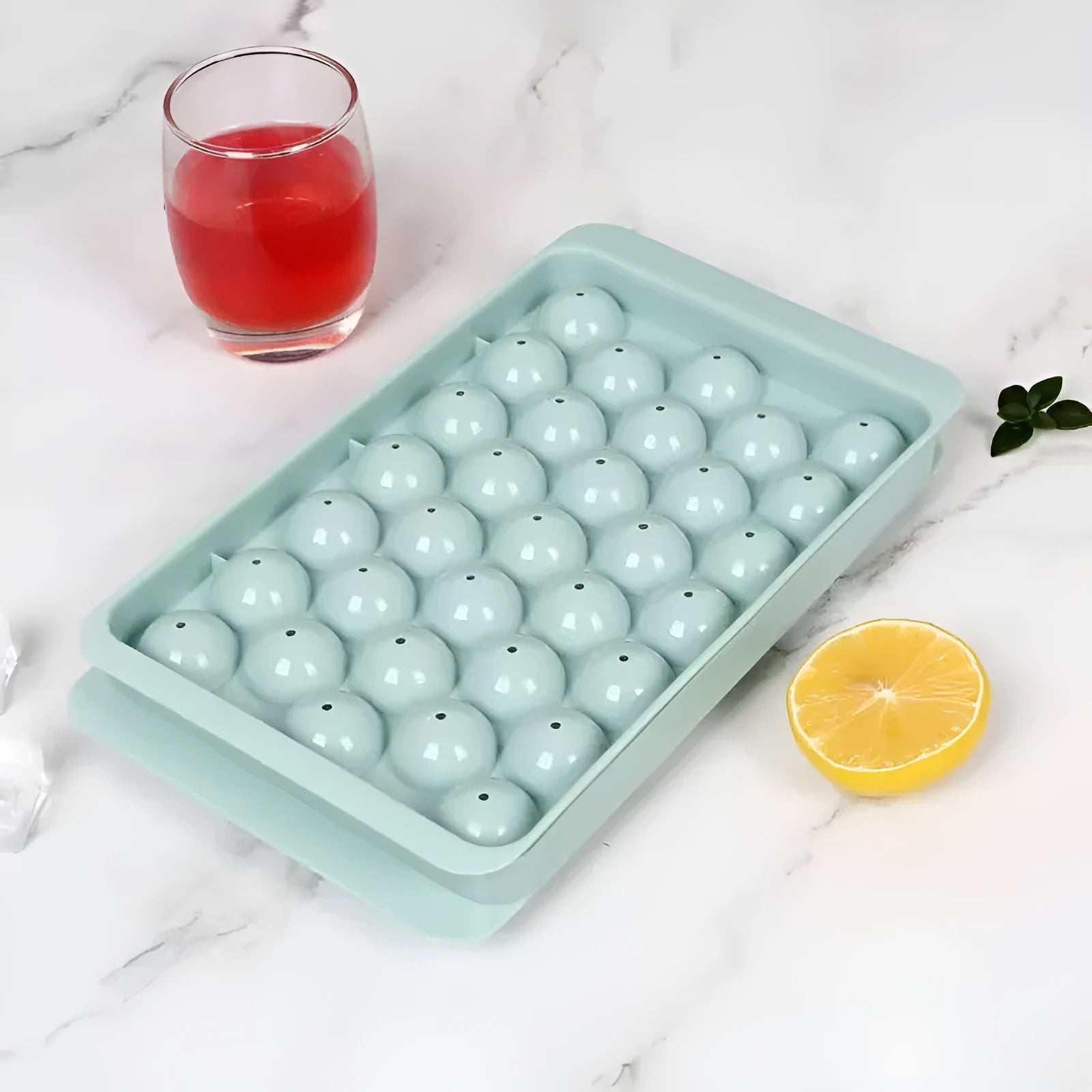 Blue silicone ice cube tray with lid showing 33 round ice moulds
