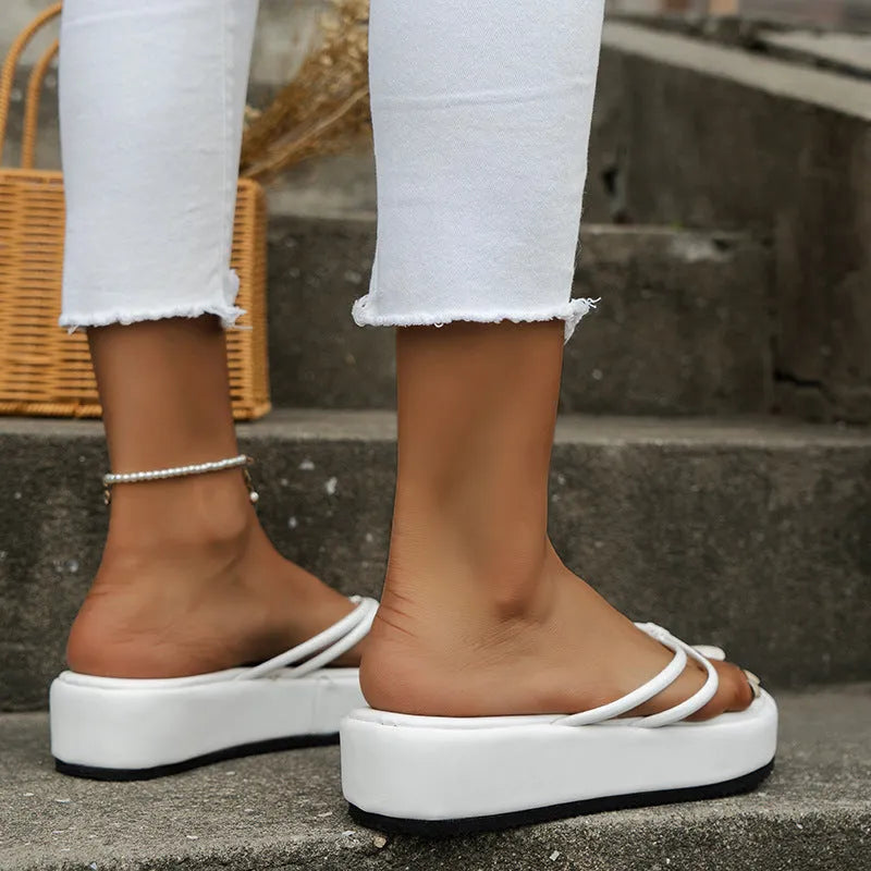 Thick-soled herringbone pattern flip-flops in multiple colours on a white background