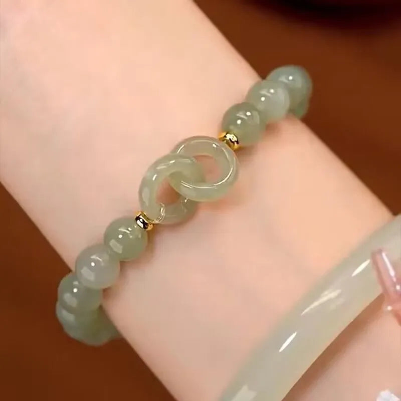 Handmade Chinese style glass bracelet with bamboo joint beads in a red Lvzhu Duobao design.