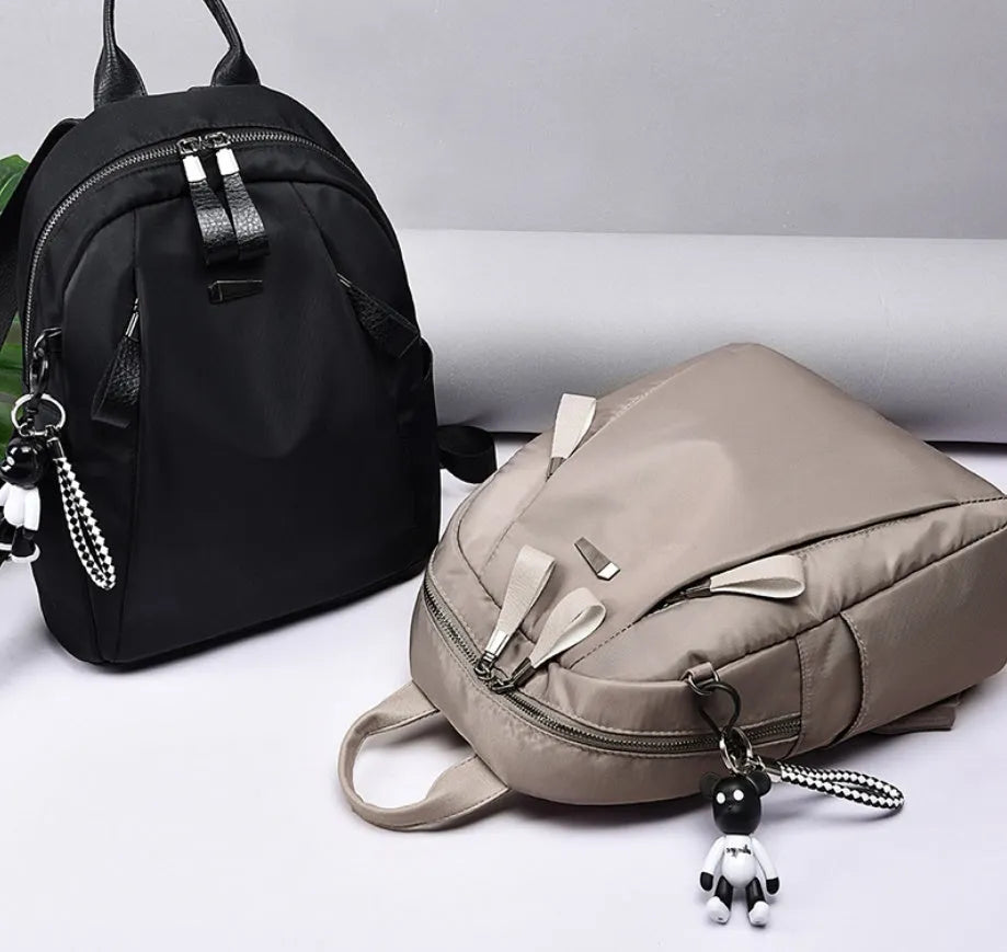 Medium square Oxford cloth rucksack in black with double straps and a front digging bag.
