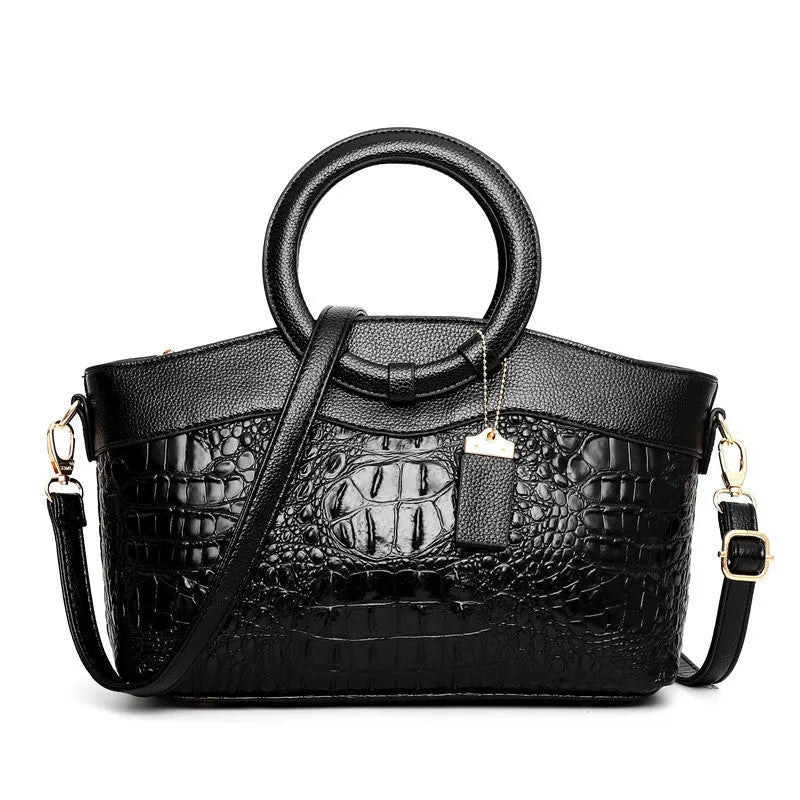 Fabric fashion handbag showing zippered compartments including mobile phone and ID pockets