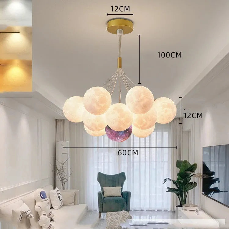 Nordic fish-shaped pendant chandelier with cluster of spherical moon bubble lights in gold or black finish.