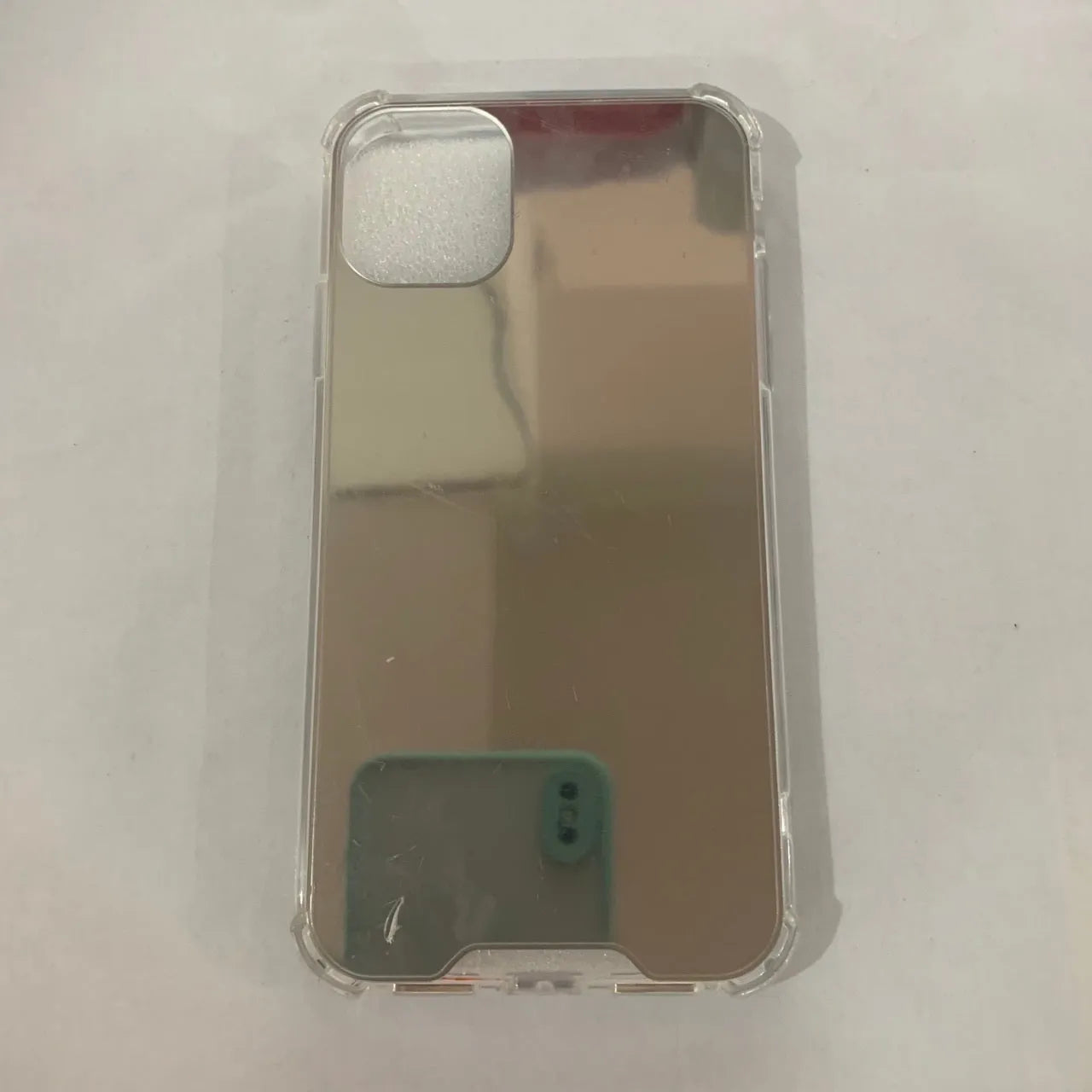 Mirrored back protective TPU case for iPhone on a table