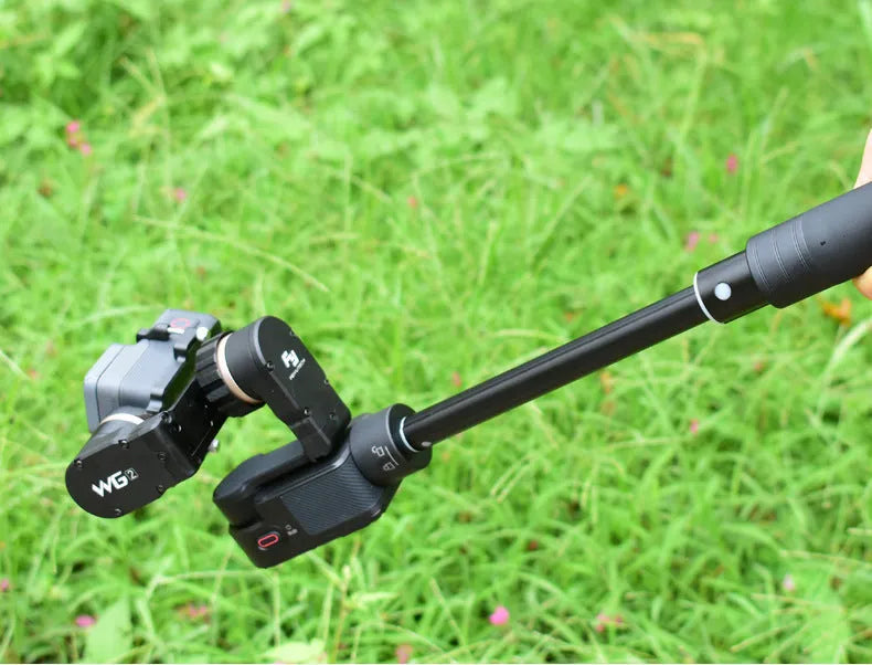 Black retractable aluminium selfie stick extended to 100cm with smartphone attached and Bluetooth remote.