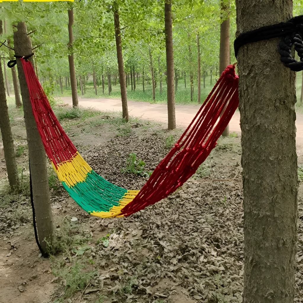 Nylon rope mesh hammock hung between trees showing open weave pattern and included tying ropes