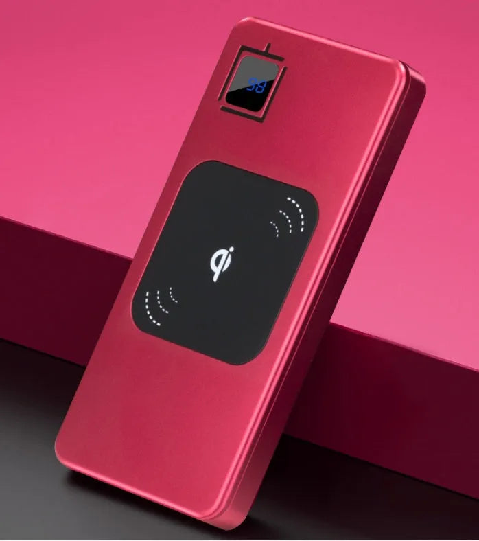 Black portable power bank with LCD display showing battery percentage, next to a smartphone for scale.
