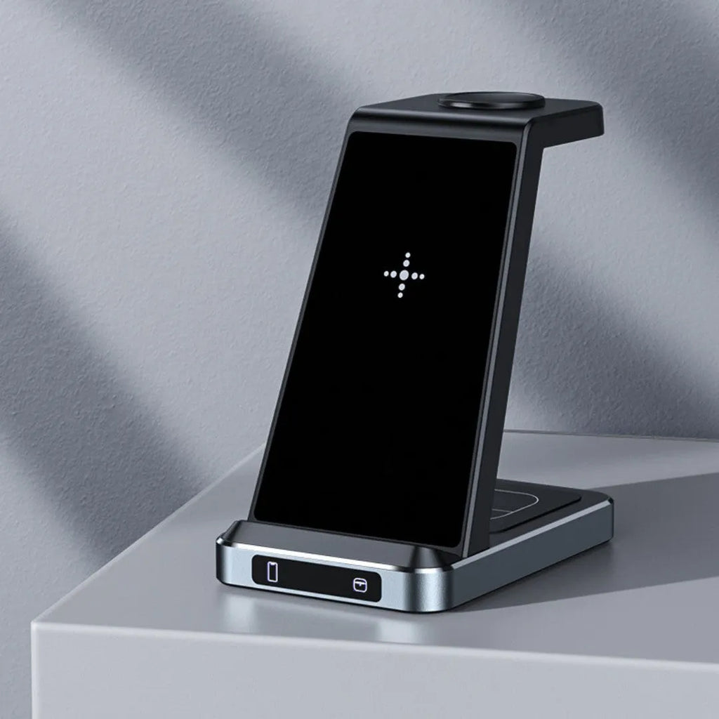 Three-in-one wireless charger in black with phone, watch, and earbuds placed on charging zones