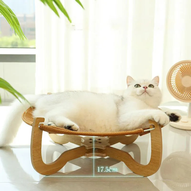 Brown square woven rattan pet hammock bed for cats and small dogs on a wooden floor.