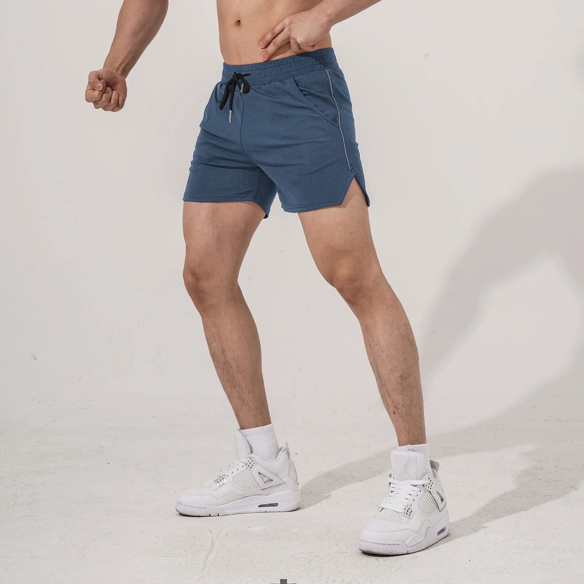 Men's straight-leg polyester fitness shorts in black, shown in a sports casual style.