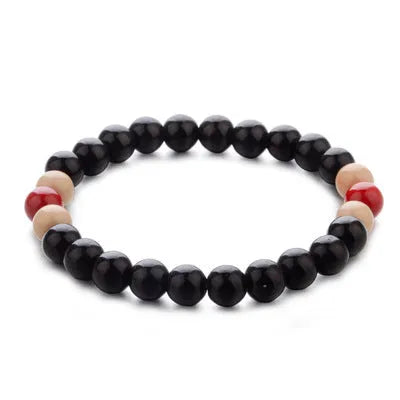 Unisex ethnic-style beaded bracelet made from natural lava stone on a wrist.