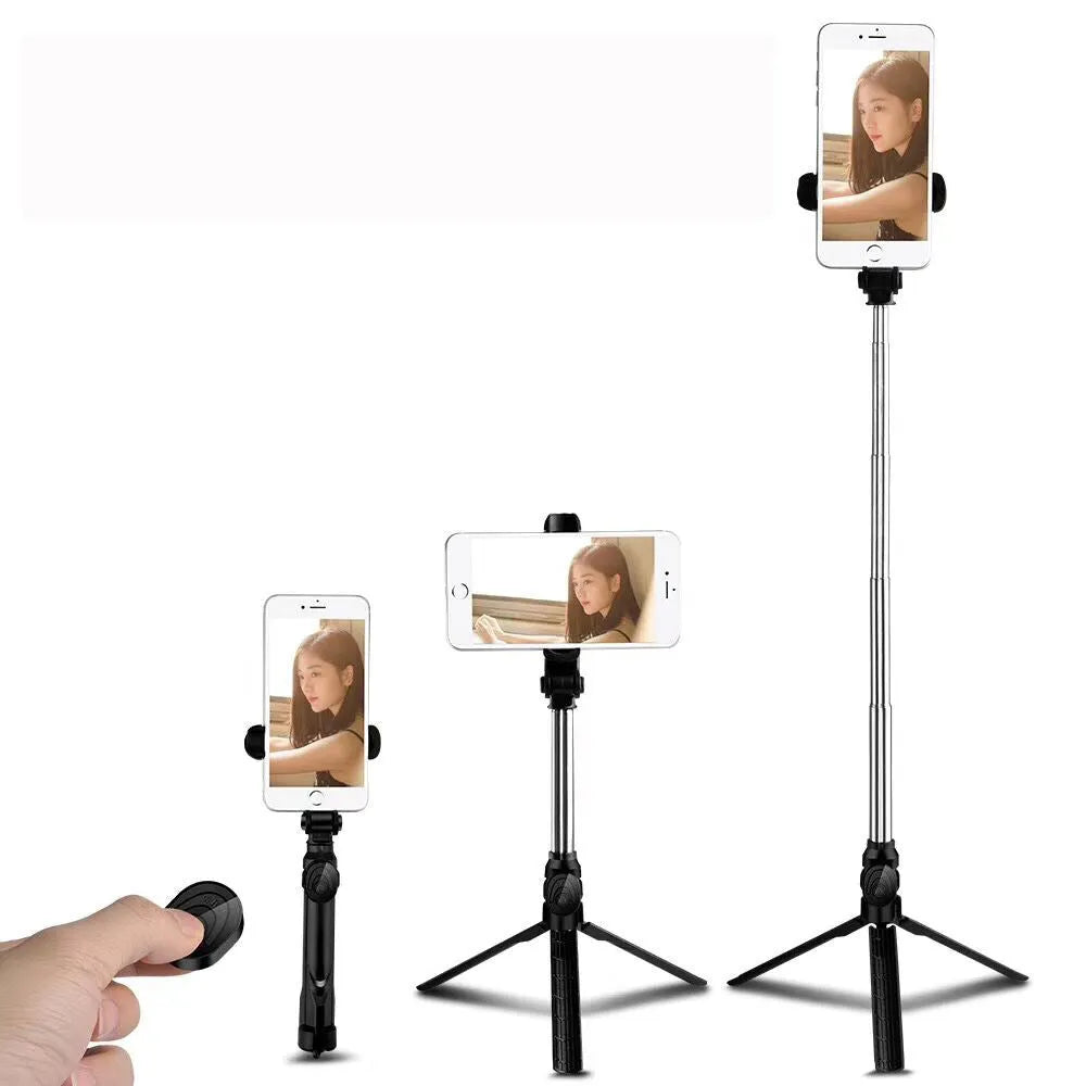 Black Bluetooth selfie tripod with extended stand and 360-degree rotating phone clip attached to an iPhone.