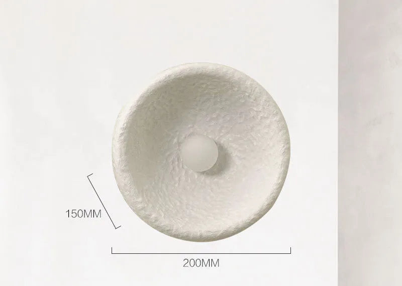 Japanese-style simple silent wall lamp with resin shade in three diameter sizes on white wall