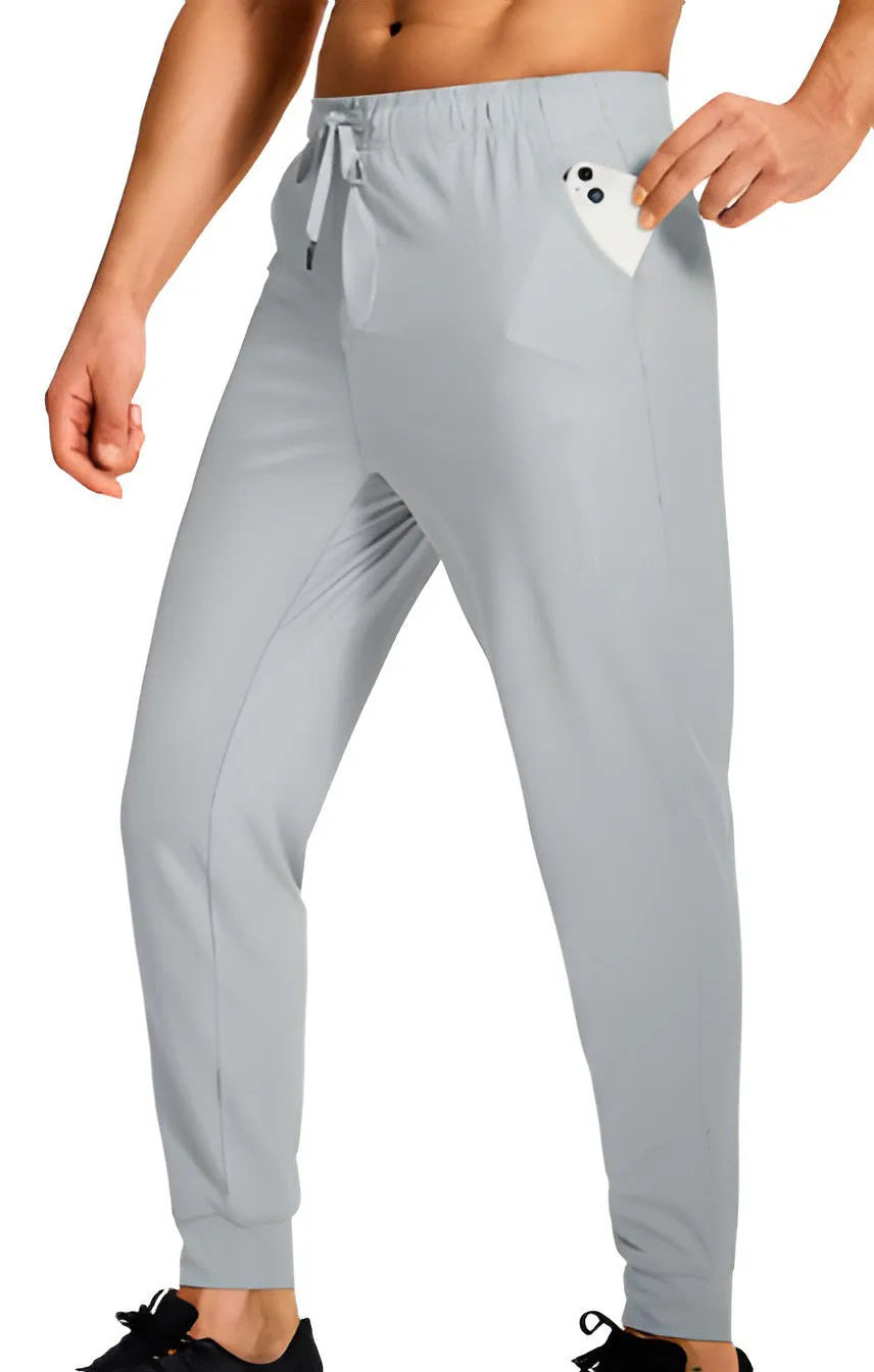 Men's loose-fitting casual polyester trousers in a solid colour on a hanger.