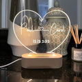 Custom engraved acrylic night light with LED base, showing personalised names and date.
