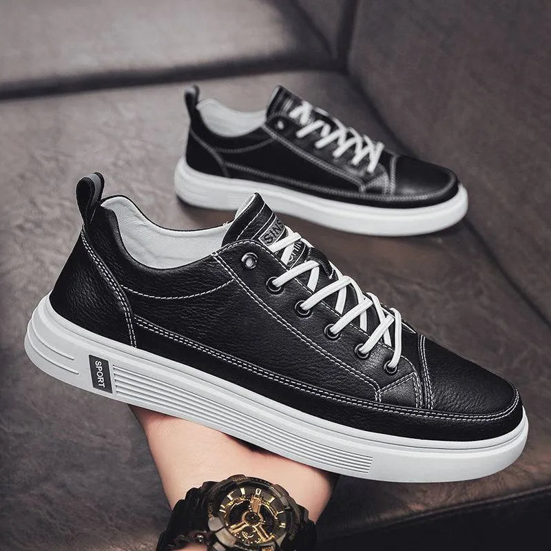 Men's casual white shoes with round toe and flat low-heel sole on a plain background.