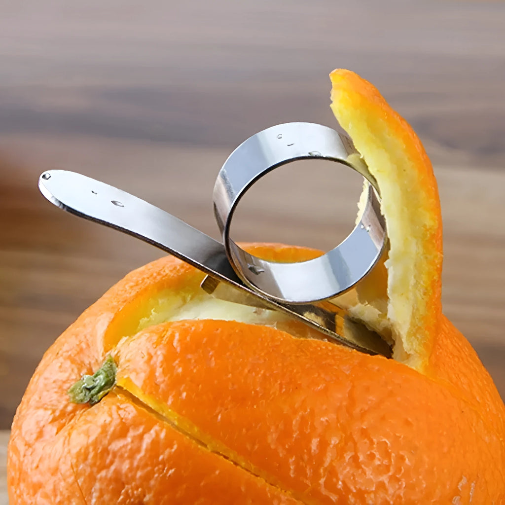 Silver stainless steel ring orange peeler on white background showing 7.5cm tool with finger ring