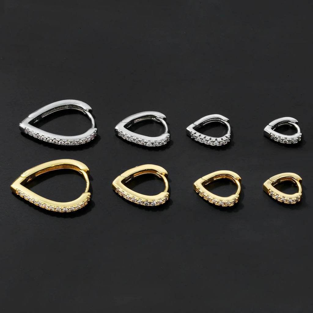 Simple geometric copper ear clip with heart design in gold or white finish.