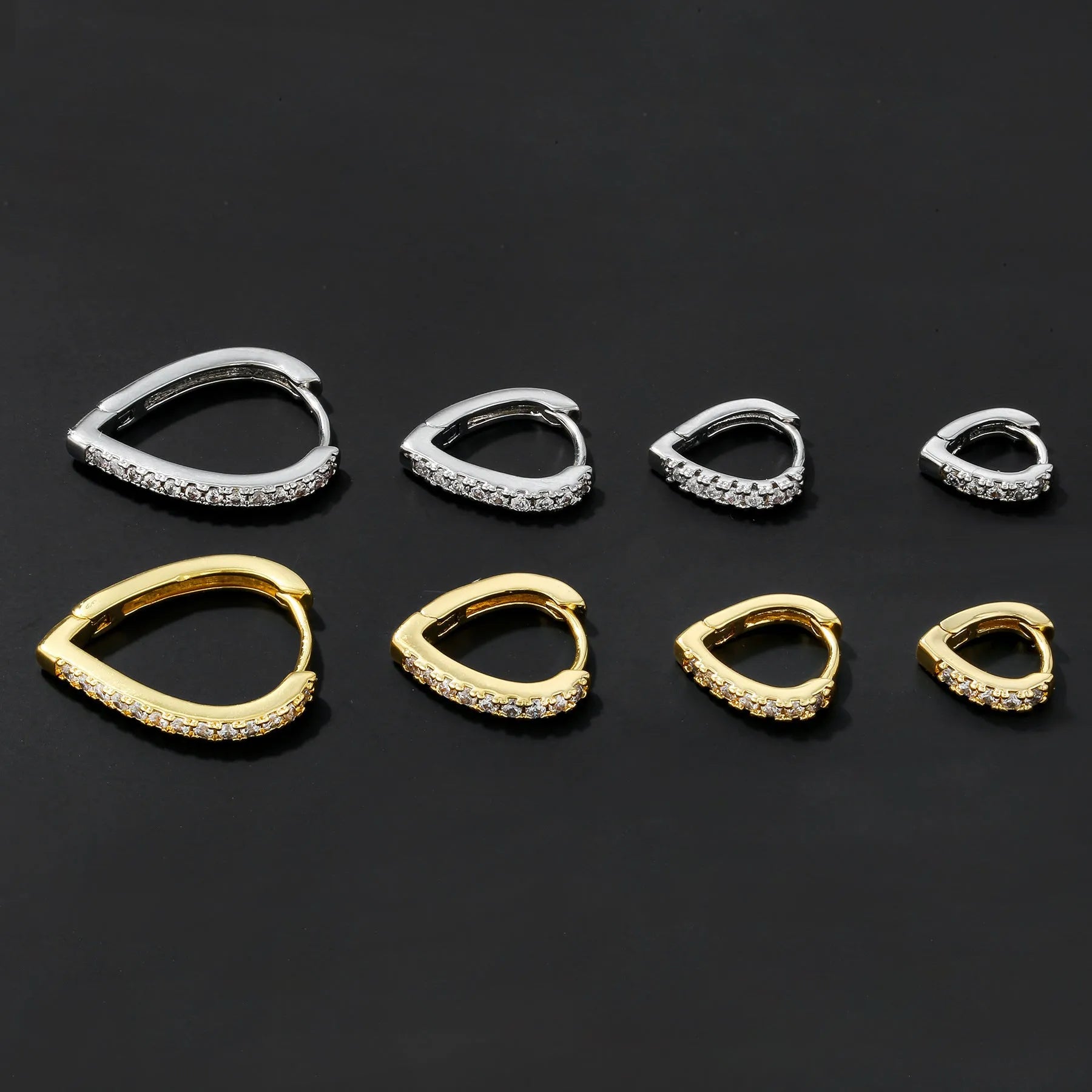 Simple geometric copper ear clip with heart design in gold or white finish.