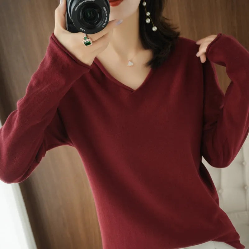Women's V-neck long sleeve knitwear pullover top in a macaron colour on a hanger.