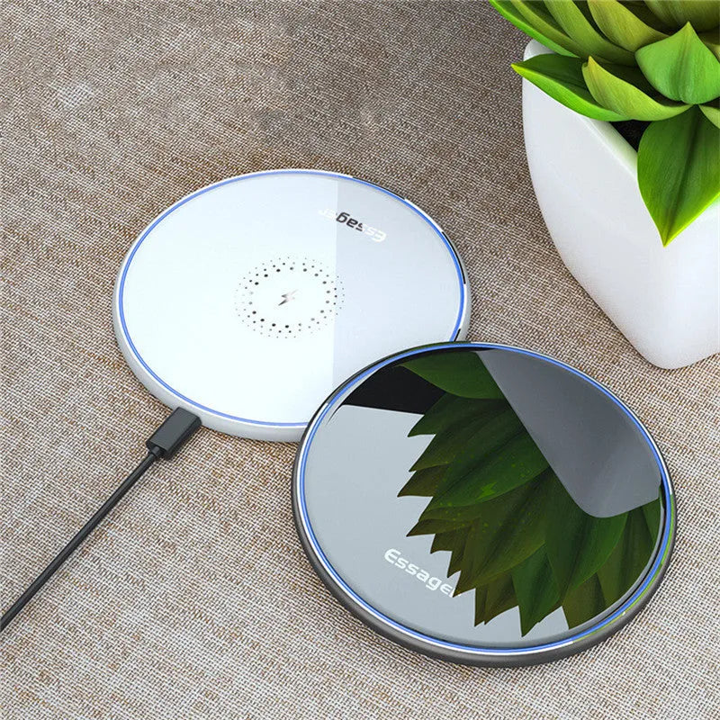 Black or white aluminium alloy 15W Qi wireless charging pad with LED light on a desk.