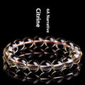 Natural citrine scattered beads ball bracelet showing polished gemstone beads on a wrist.