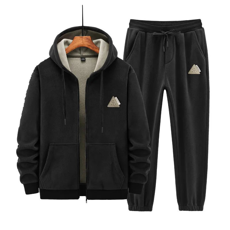 Man wearing a grey hooded sweater and matching trousers from a men's two-piece casual sports suit set.