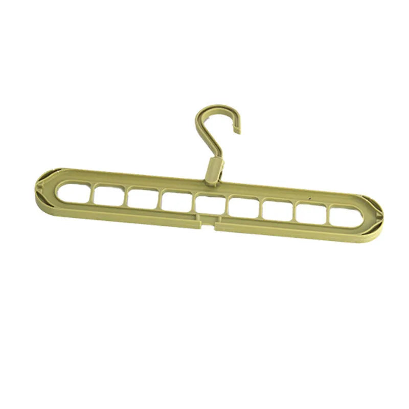 Green plastic nine-hole folding hanger for trousers shown in a dormitory wardrobe.