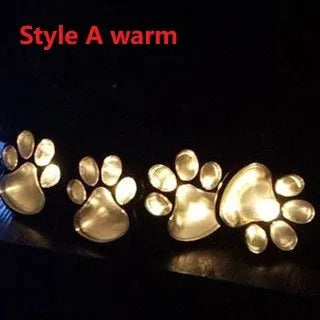 Black bear paw shaped solar garden lights with four paw prints connected to solar panel