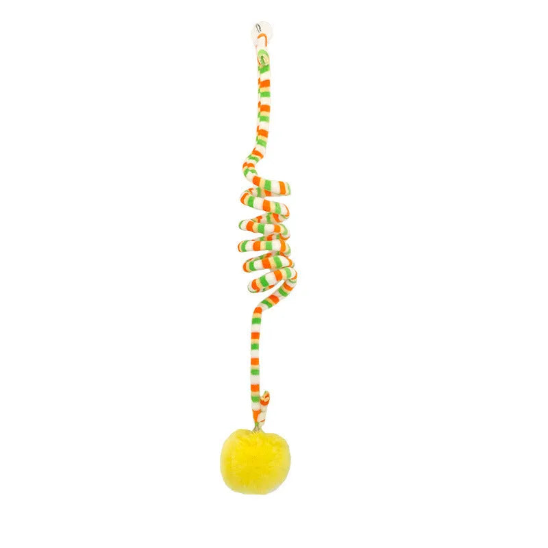 Kitten playing with a spring-mounted hanging ball toy attached to a door by a suction cup.