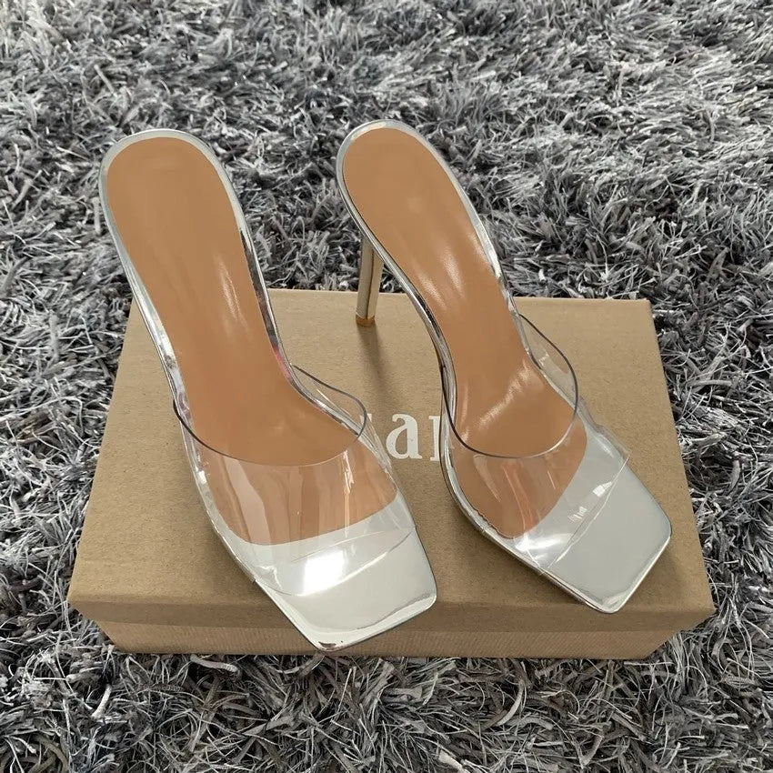 Women's black and silver high heel shoes showing side profile on white background