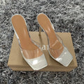 Women's black and silver high heel shoes showing side profile on white background