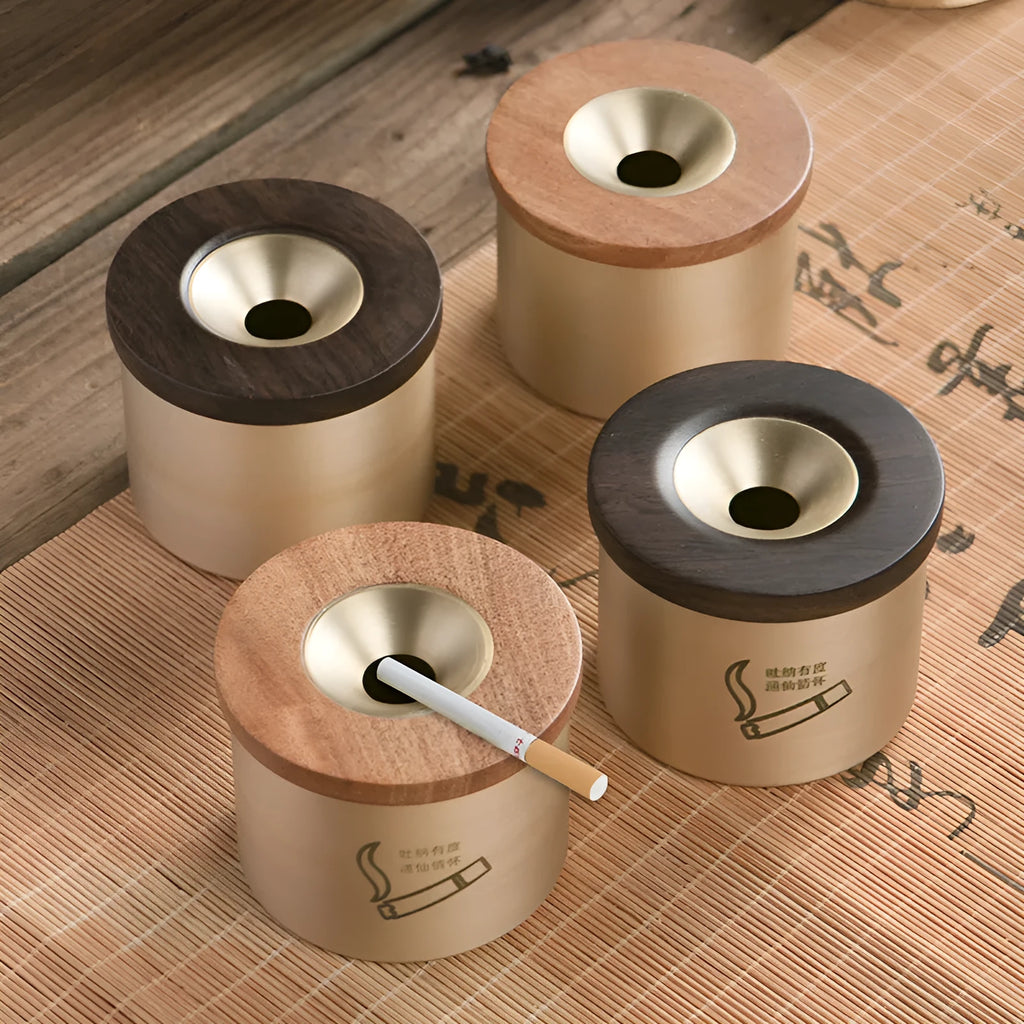 Brass ashtray with wooden lid showing central hole design for ash collection