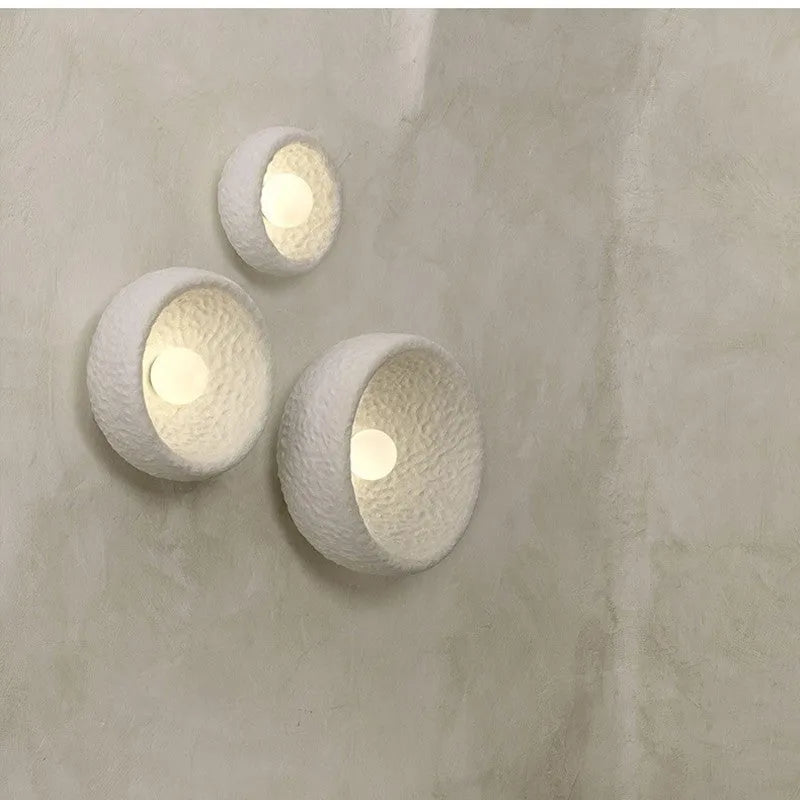 Japanese-style simple silent wall lamp with resin shade in three diameter sizes on white wall