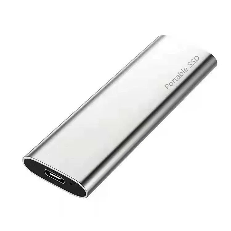 Red ultra-thin metal external SSD hard drive with high storage capacity on a desk.